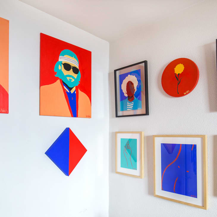 Colorful modern art gallery wall with abstract portraits, geometric shapes, and line drawings in vibrant frames.
