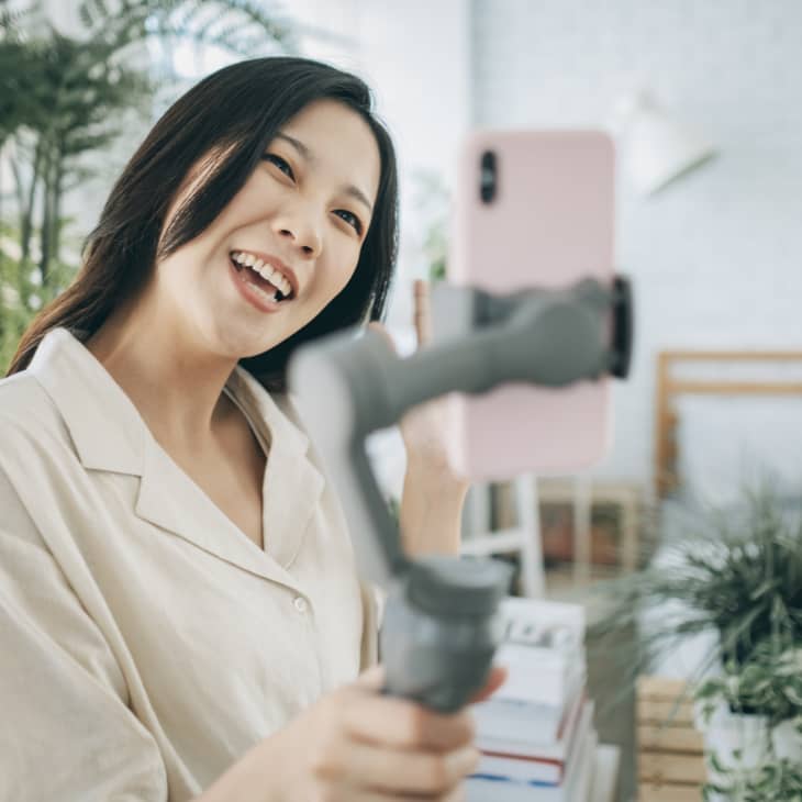 Asian woman using steady cam with smartphone