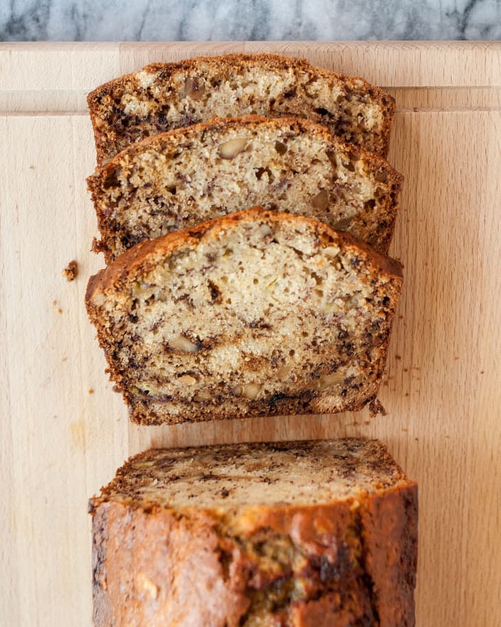 Loaf of banana bread with three slices cut to show interior