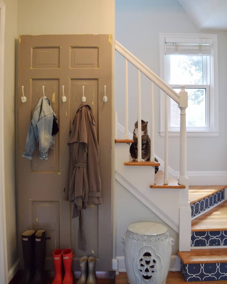 Hooks hung up on the back of a door to hang coats