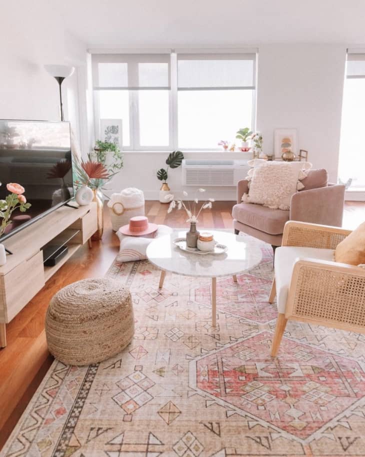Pink and boho living room with lots of plants and flowers
