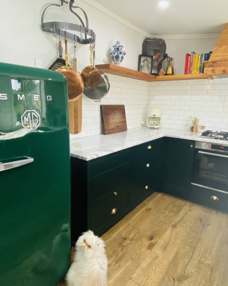 Kitchen with dark lower cabinets and green Smeg