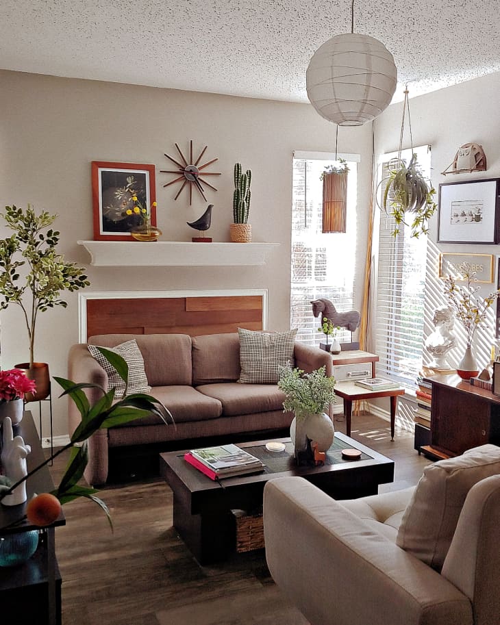 Living room with art, plants,  and couches