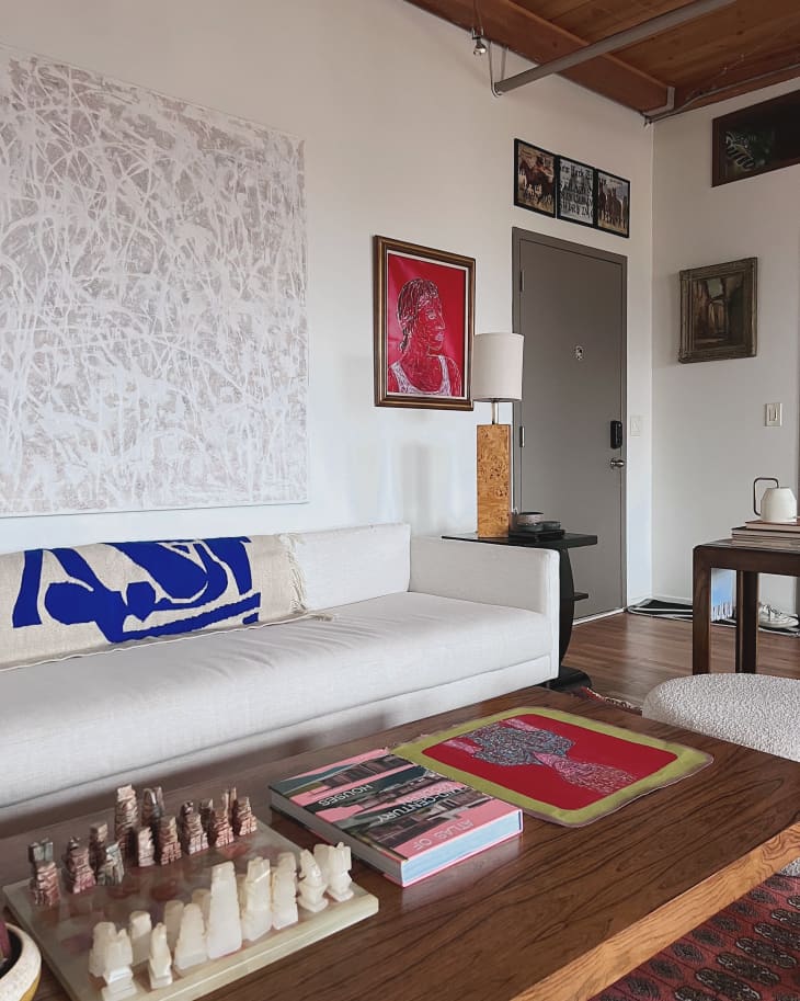 Living room with long white sofa and wooden coffee table