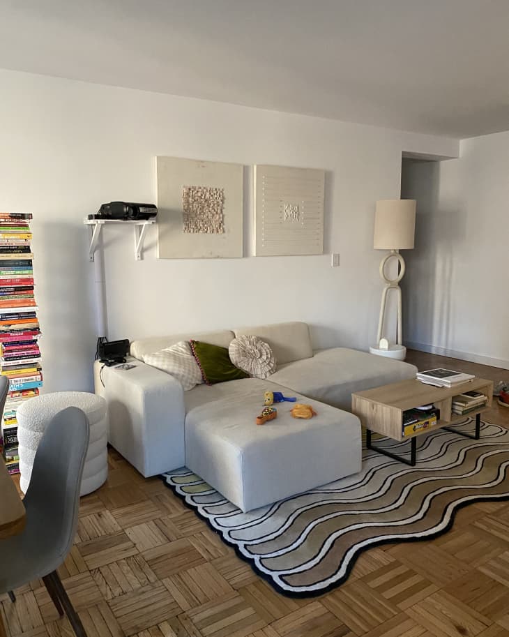 A white sectional sofa with a rug underneath