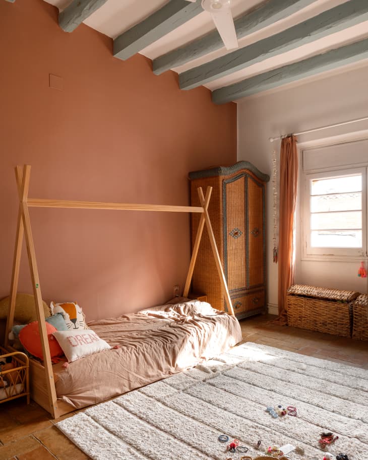 Kids bed in pink painted bedroom.