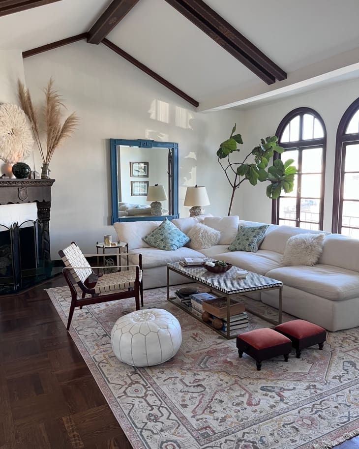 A large white living room with a sectional white sofa
