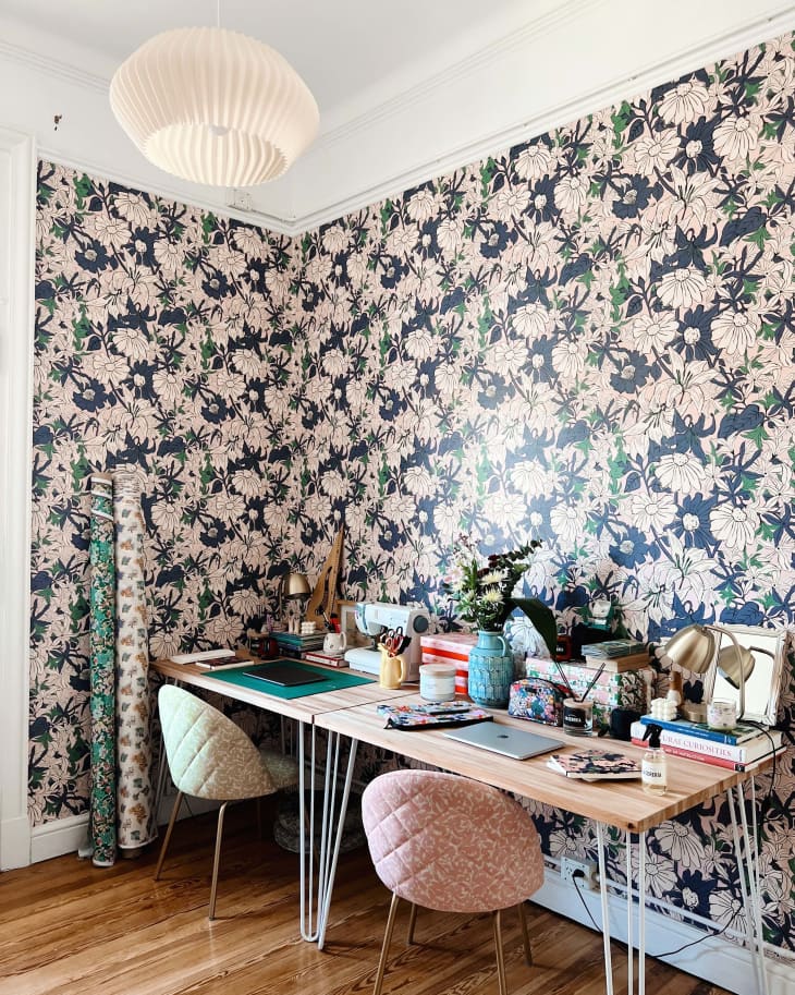 An office space with pink floral wallpaper