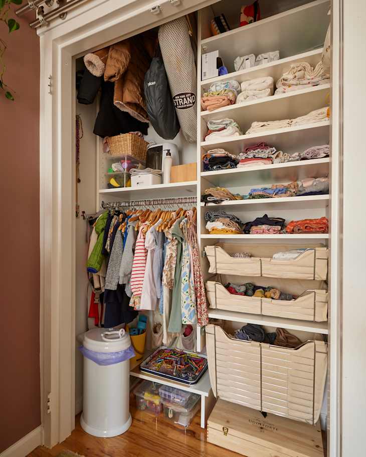 Children's clothes neatly organized in closet.