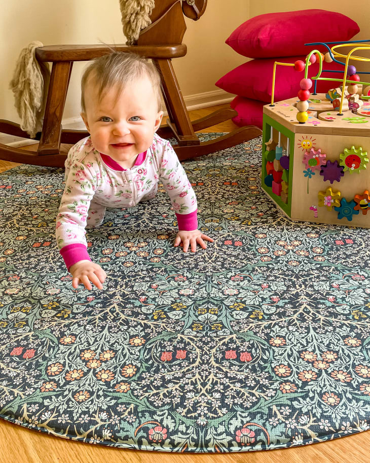 baby playing on Morris &amp; Co. The Blackthorn Play Mat with toys around