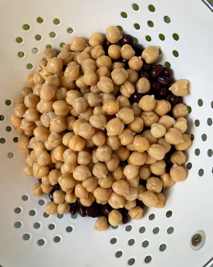 Chickpeas and black beans in a colander