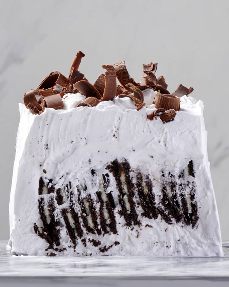 photo of an icebox cake with Oreo thins as the filling and chocolate curls as a topping on a marble surface