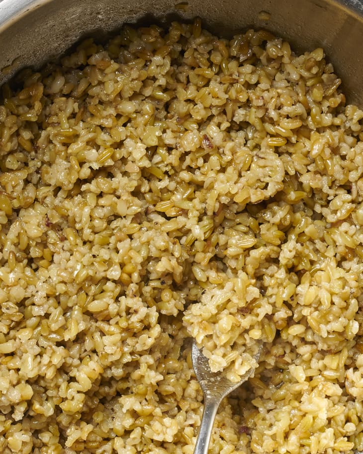 freekeh in bowl being fluffed with fork
