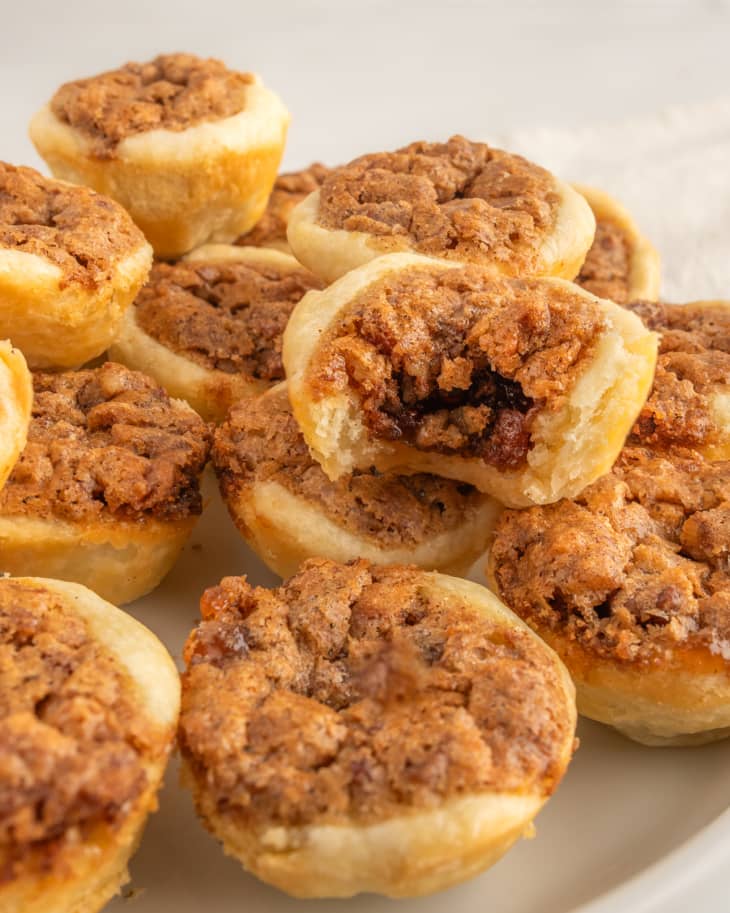 pecan tassie cups on plate with bite taken out of one