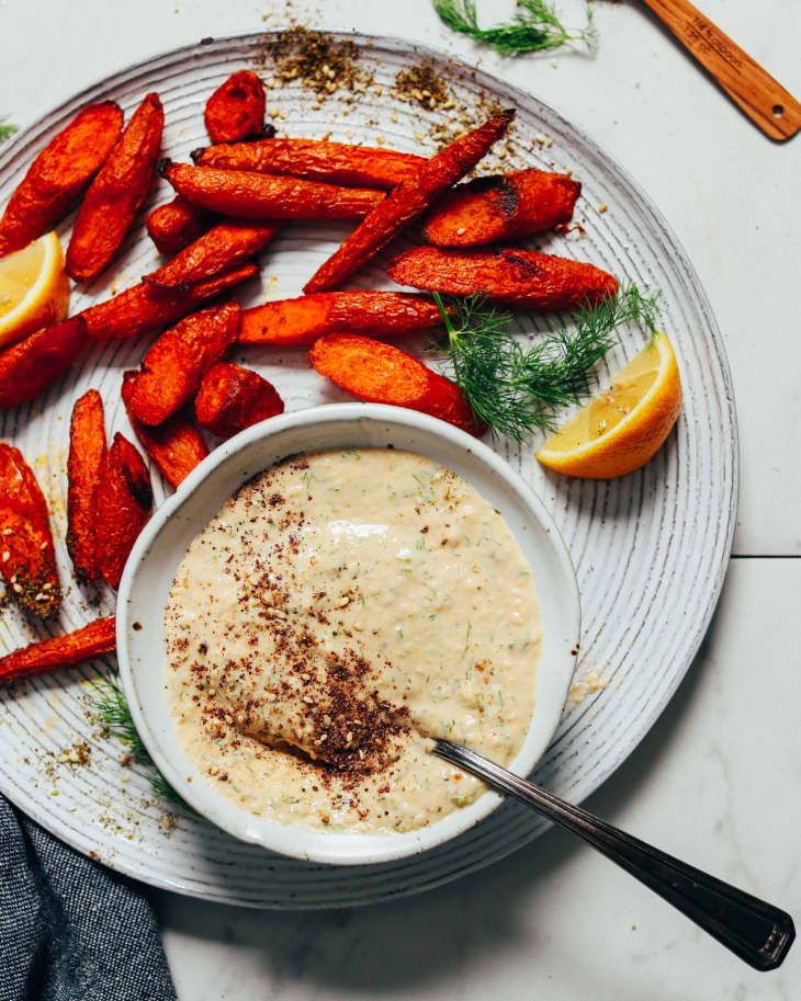 garlic dill sauce on plate with roasted carrots