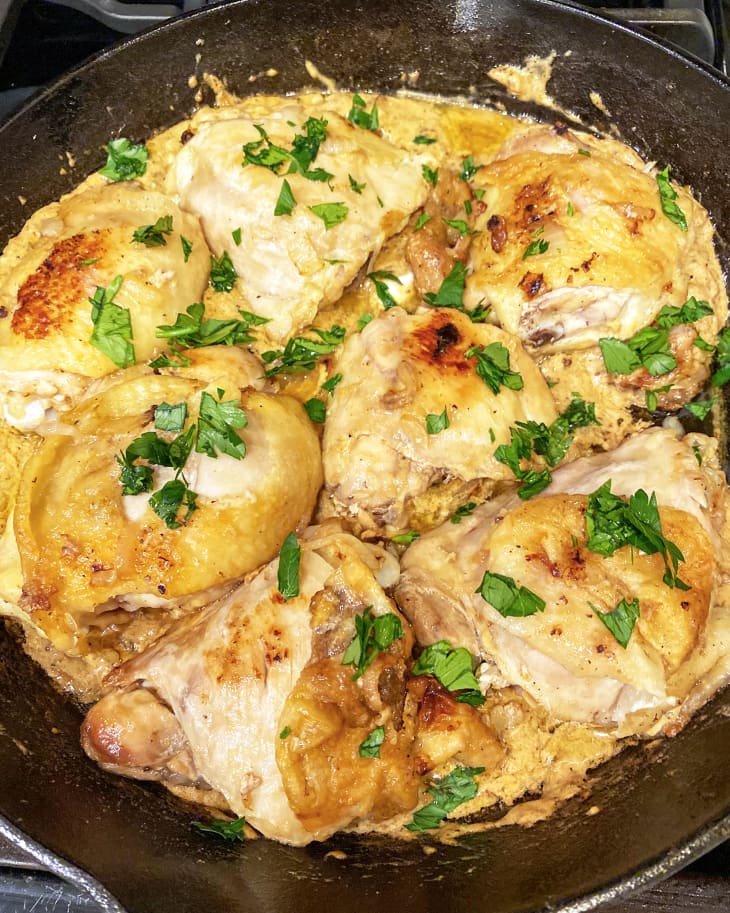 chicken thigs in a pan garnished