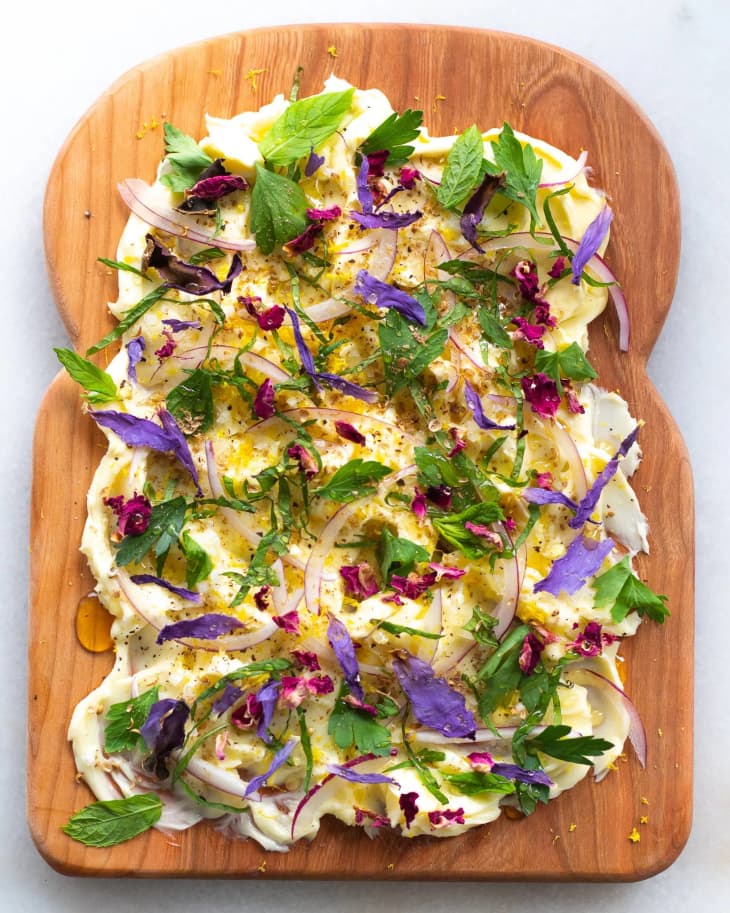 butter board styled with edible flowers and onions.