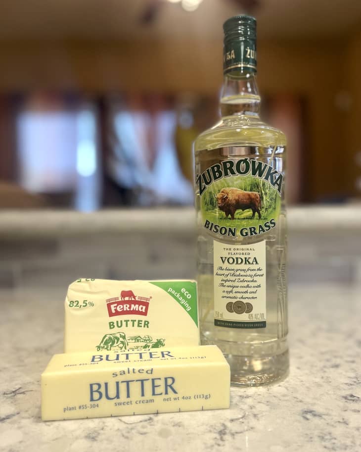a bottle of bison grass vodka and some sticks of butter on a countertop