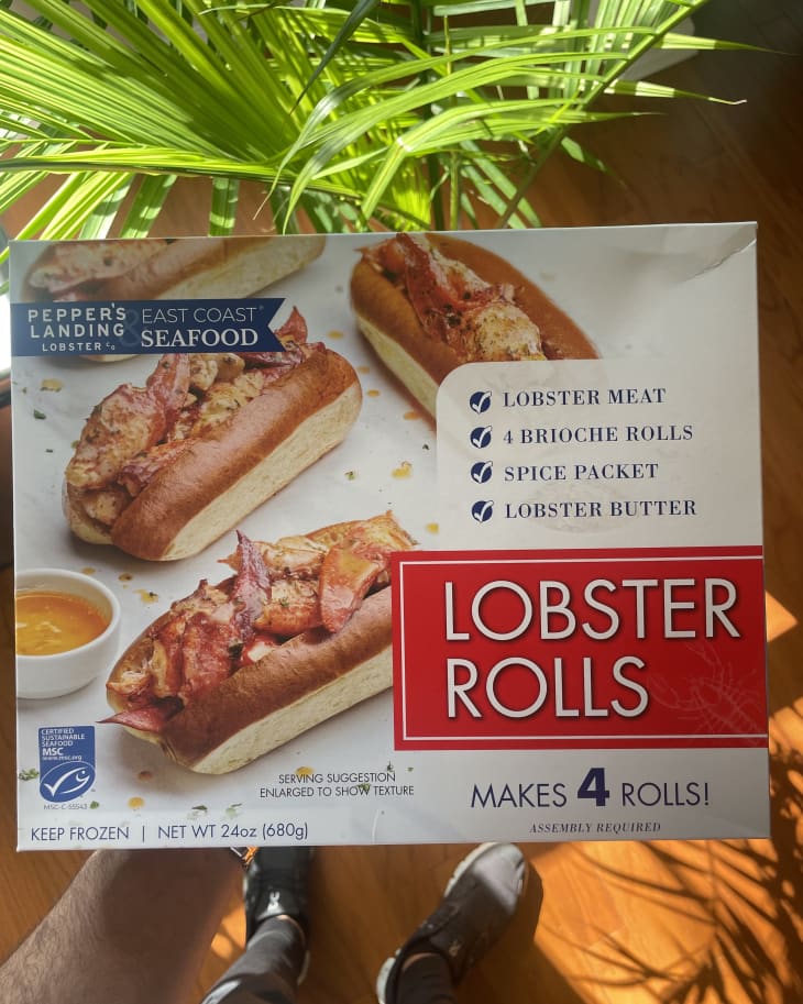 Someone holding package of lobster rolls kit.