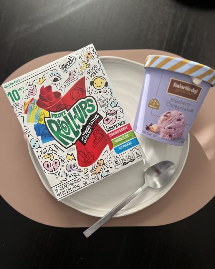 Packages of Fruit Roll Ups and Ice Cream on plate with spoon on the side.