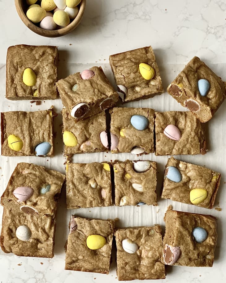 Easter egg blondies cut into squares on surface.