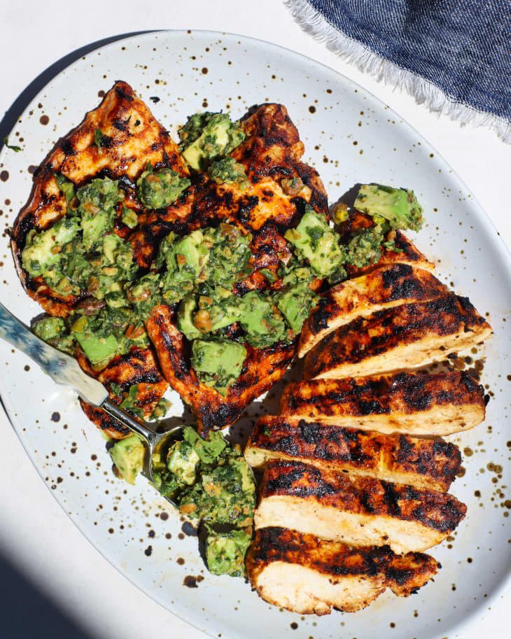 Grilled chicken with pistachio avocado relish drizzled on top.