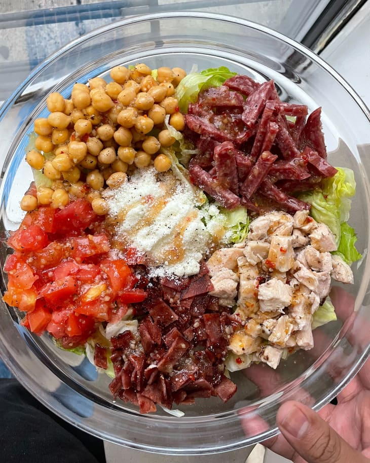 salad with multiple ingredients in glass shallow bowl