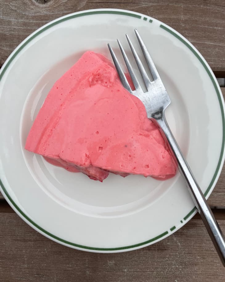 Strawberry nervous pudding served on a plate with fork on the side.