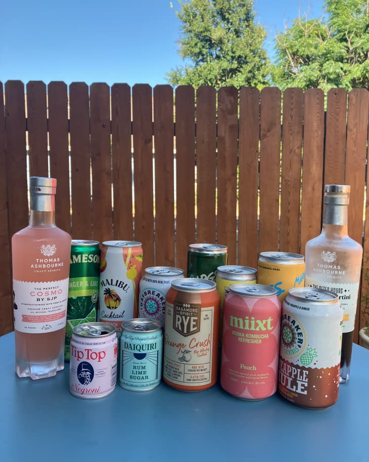 Variety of canned cocktails on outdoor dining table.