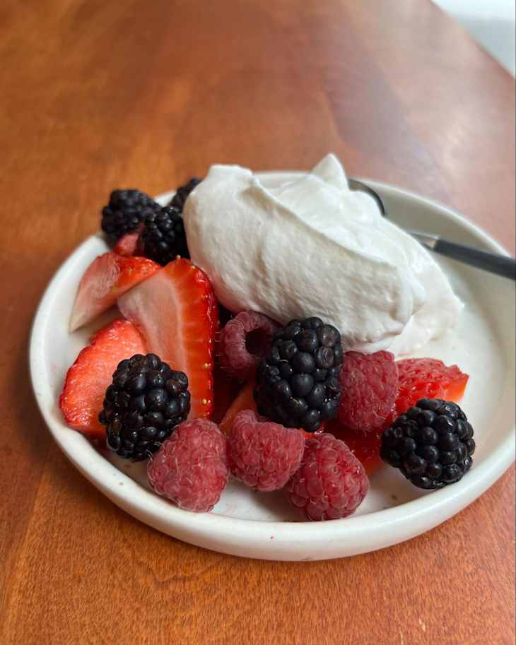 Fresh berries on a plate with yogurt.