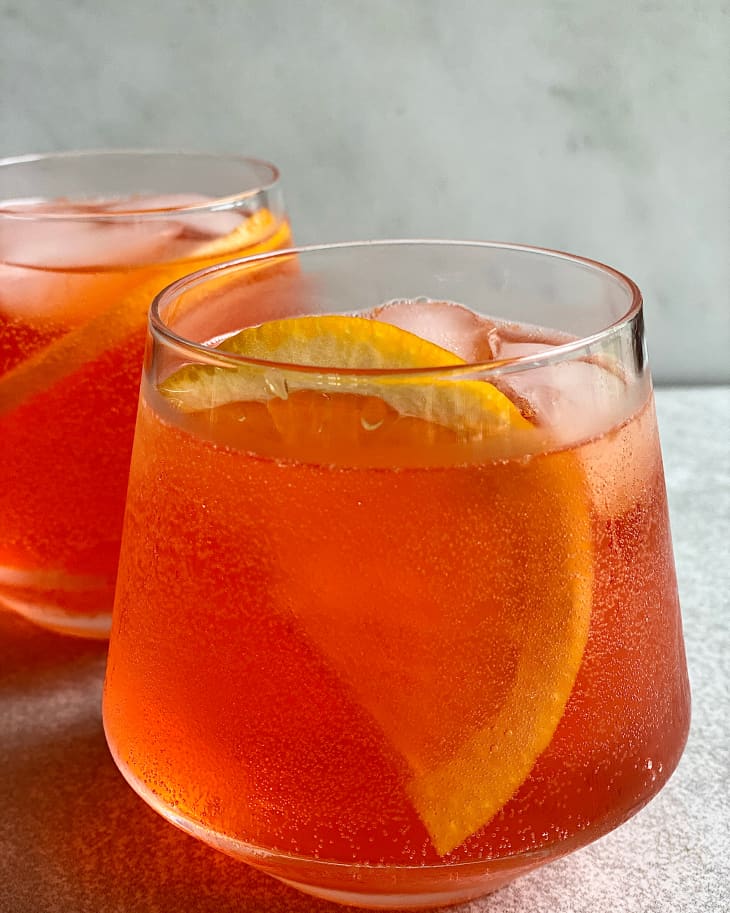 Sparkling spritz punch in glass with slice of orange on the side.