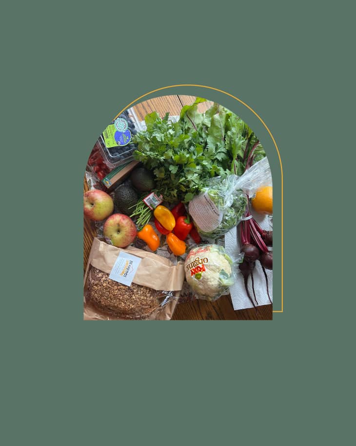 Grocery haul on table framed in an arch on a colored graphic background