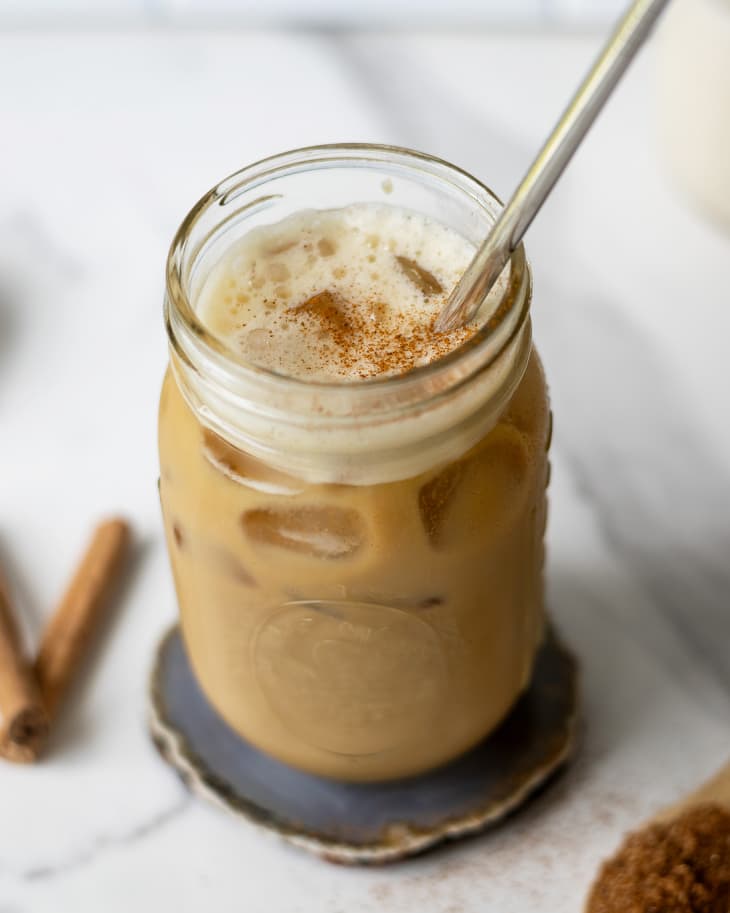 shaken espresso in a jar with a straw on a countertop