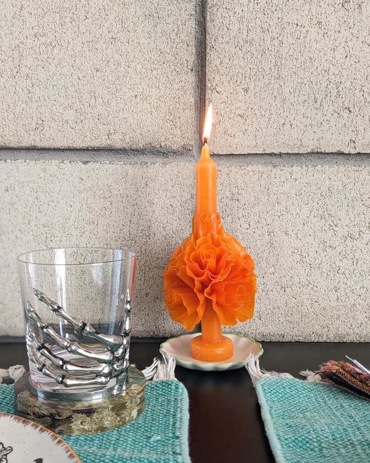 Mexican floral taper candle on dining room table.