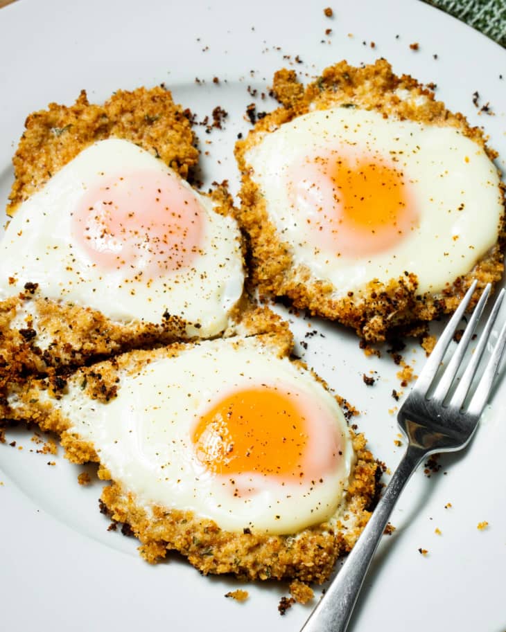 Fried eggs on bed of breadcrumbs on plate