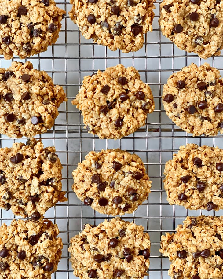 Freshly baked oatmeal cookies on baking rack.