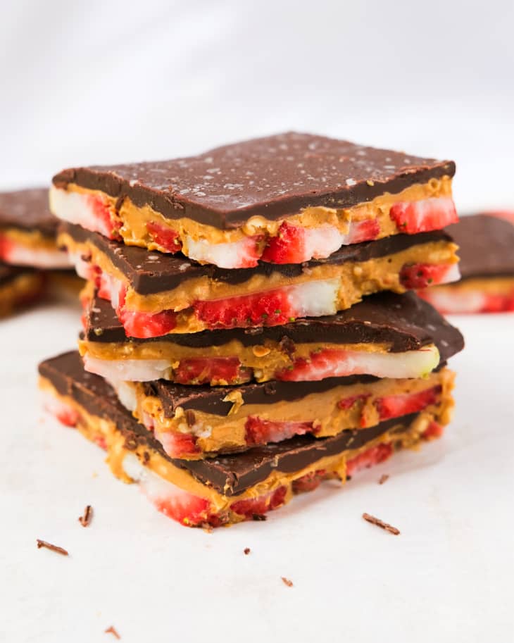 Strawberry peanut butter chocolate bark squares stacked.