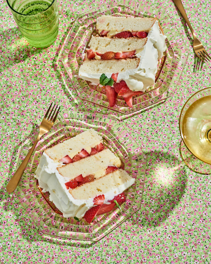 strawberry cake slices on table next to glasses