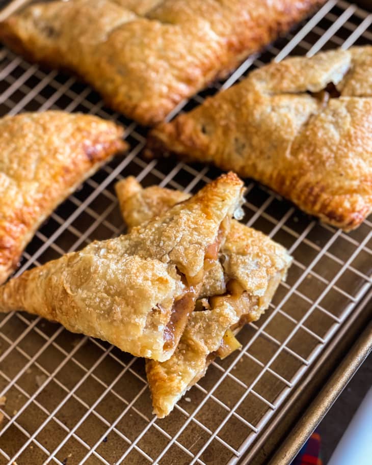 Apple Turnover on a cooling rack, with one piece cut in half so that you can see the filling