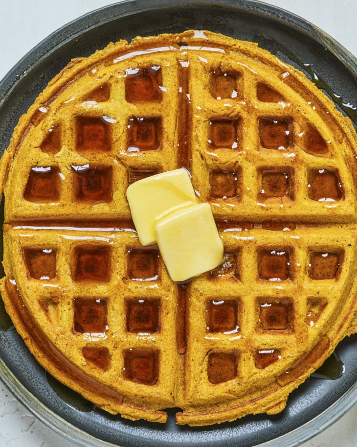a pumpkin waffle with syrup and butter