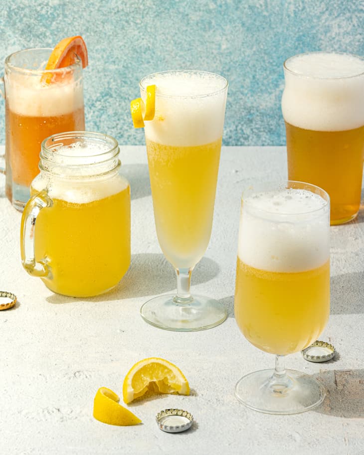 summer shandy in five types of glassware with lemon wedges and beer caps