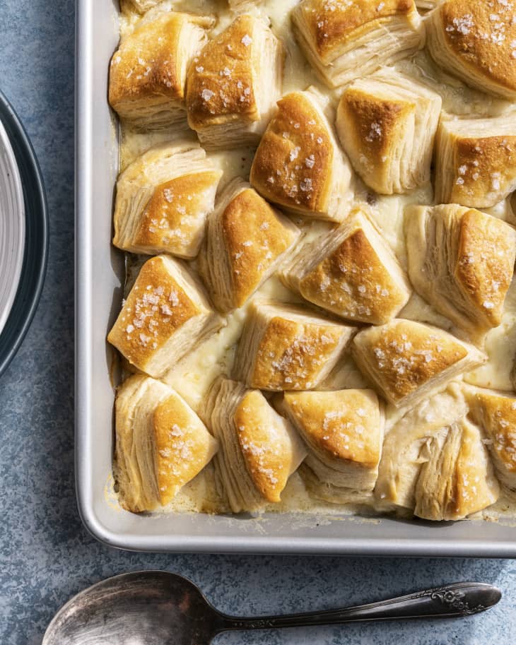 Biscuits and Gravy Casserole, with a creamy chicken with white gravy bottom and biscuits baked across the top in a baking tin.