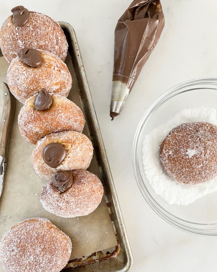 Bomboloni (Italian Donuts) with chocolate cream filling and a sugar dusted coating.