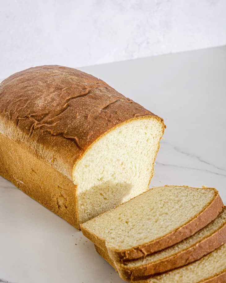 a three quarter angle view of potato bread, with a few slices cut from the loaf.