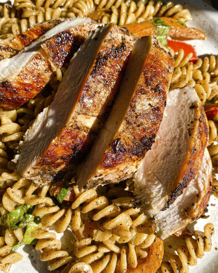 a Caribbean creamy pasta with jerk chicken sliced on top
