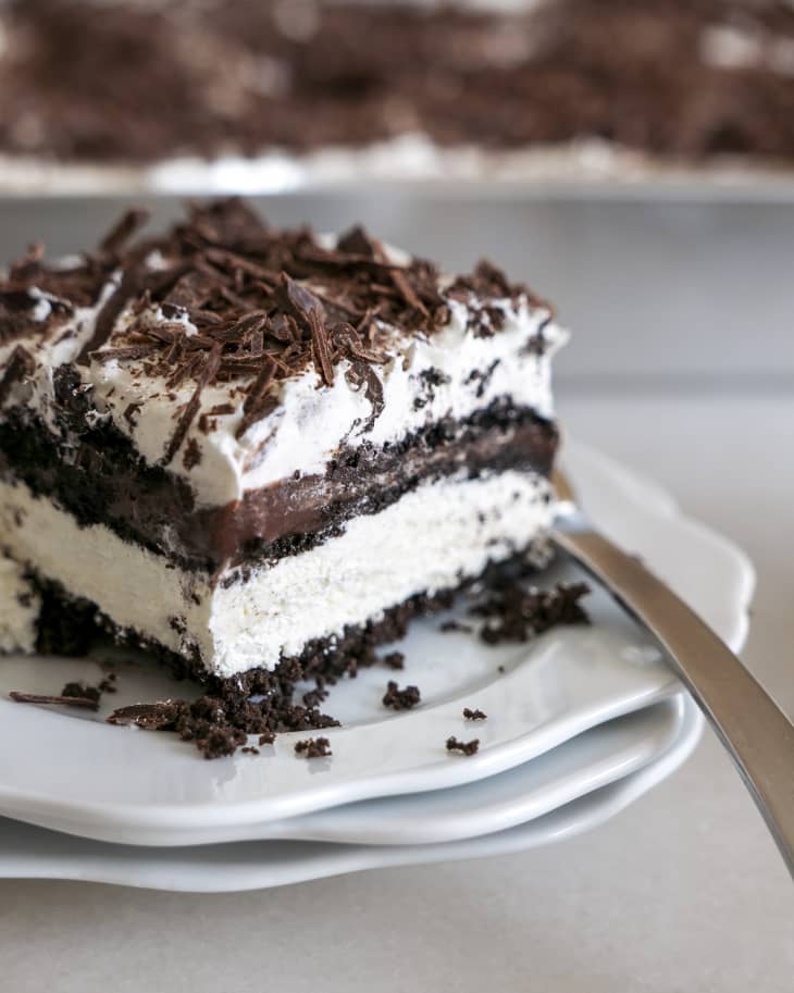 a piece of Chocolate lasagna (chocolate cream pie with alternating layers of chocolate and cream) on a plate with a fork on the side