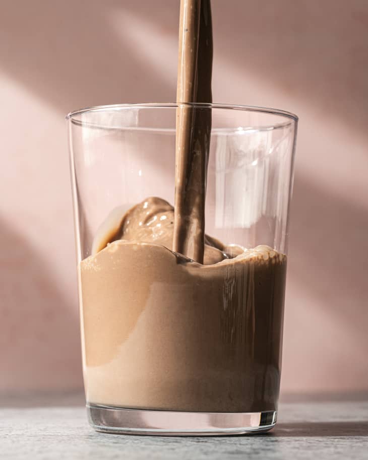 Chocolate milk being poured into a glass