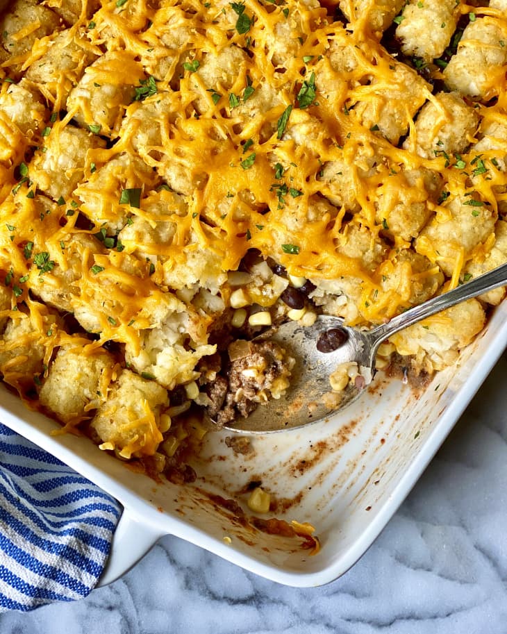 Cowboy casserole (a casserole with ground beef and other ingredients, topped with tator tots and melted cheese