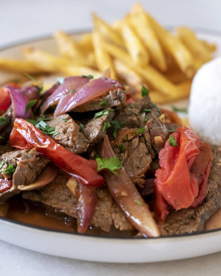 Lomo saltado is a popular, traditional Peruvian dish, a stir fry that typically combines marinated strips of sirloin with onions, tomatoes, french fries, and other ingredients; and is typically served with rice.