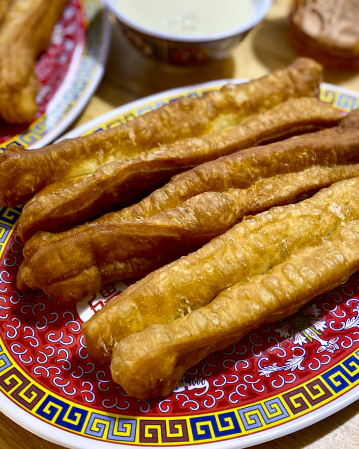 Youtiao on a plate (long golden-brown deep-fried strip of dough commonly eaten in China and in other East and Southeast Asian cuisines; a type of Chinese doughnut).